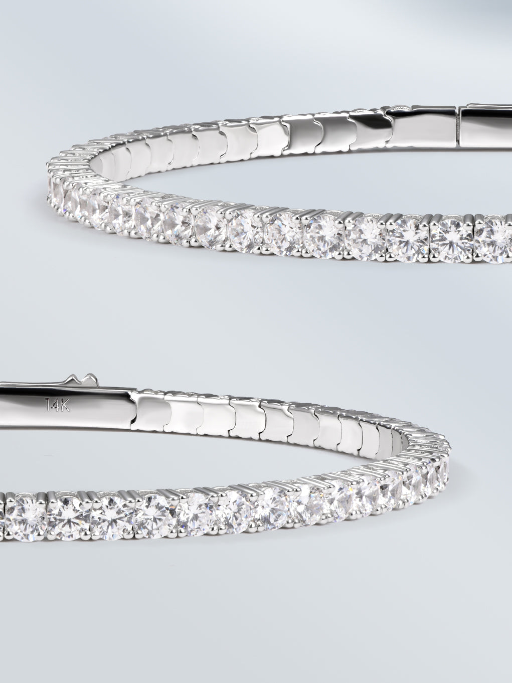 Two silver bracelets with diamond accents on a light gray background