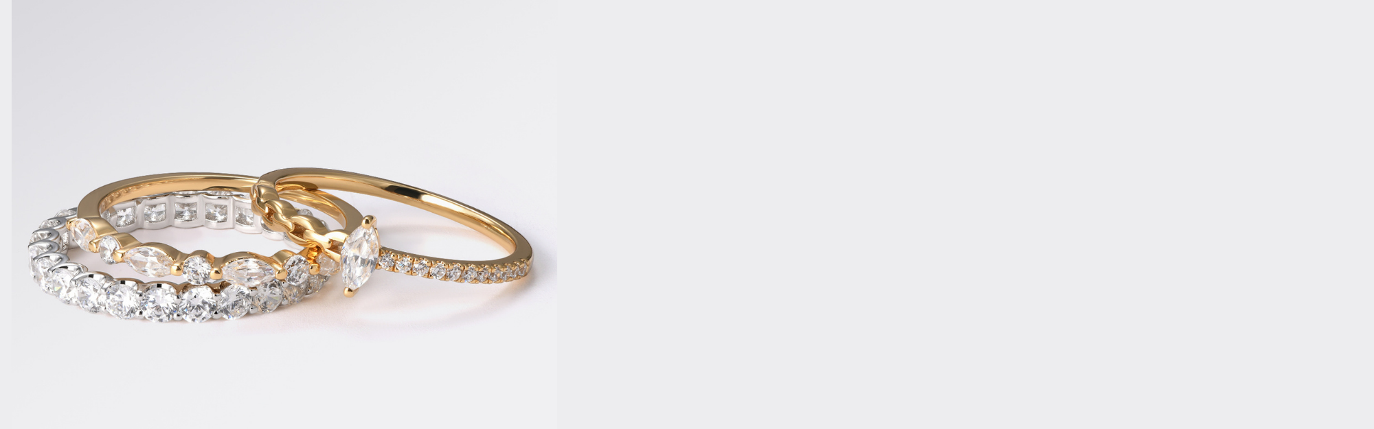 Two gold rings with diamond accents on a light gray background
